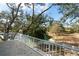 Balcony view overlooking a green space, with blue skies and greenery in the background at 1228 Wagon Wheel Dr, Sarasota, FL 34240