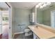 Bathroom with a large mirror over vanity, updated fixtures and tile, and a connected hallway at 1228 Wagon Wheel Dr, Sarasota, FL 34240