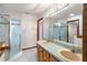 This bathroom has a glass enclosed shower, white tile floor, and a double sink at 1228 Wagon Wheel Dr, Sarasota, FL 34240