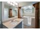 Bathroom with a walk-in tub, tile flooring, and a vanity with a large mirror at 1228 Wagon Wheel Dr, Sarasota, FL 34240