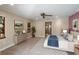 This is a beautiful bedroom with a ceiling fan and an ensuite bathroom with glass shower at 1228 Wagon Wheel Dr, Sarasota, FL 34240