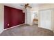 Empty bedroom has carpet, a dark accent wall, a built in desk area, and multiple closets at 1228 Wagon Wheel Dr, Sarasota, FL 34240