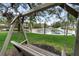 Outdoor bench overlooking a pond with a fountain, providing a serene setting at 1228 Wagon Wheel Dr, Sarasota, FL 34240