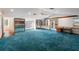 Bonus room showcasing blue carpet, a ceiling fan, built-ins, and an outdoor view at 1228 Wagon Wheel Dr, Sarasota, FL 34240