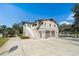 Inviting two-story home with a three-car garage, front entry staircase and mature trees at 1228 Wagon Wheel Dr, Sarasota, FL 34240
