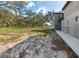 Exterior of gray barn building, surrounded by lush greenery and a white perimeter fence at 1228 Wagon Wheel Dr, Sarasota, FL 34240