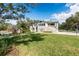 Expansive home with a lush green lawn and charming shed, perfect for outdoor enjoyment at 1228 Wagon Wheel Dr, Sarasota, FL 34240