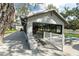 Rear exterior of the clubhouse showcasing large windows and patio with seating at 1228 Wagon Wheel Dr, Sarasota, FL 34240