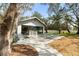 Exterior view of the clubhouse featuring picnic tables, and a surrounding landscape at 1228 Wagon Wheel Dr, Sarasota, FL 34240