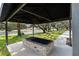 Outdoor grill with an iron trellis overlooking green grass at 1228 Wagon Wheel Dr, Sarasota, FL 34240
