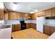 Charming kitchen with ample cabinet space, black appliances, and tiled floors at 1228 Wagon Wheel Dr, Sarasota, FL 34240