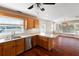 Open-concept kitchen with a breakfast bar, wood cabinets, stainless steel appliances, and adjacent dining area at 1228 Wagon Wheel Dr, Sarasota, FL 34240
