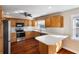 Cozy kitchen features stainless steel appliances, and light wood cabinetry at 1228 Wagon Wheel Dr, Sarasota, FL 34240