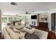 Open concept living room features a fireplace, hardwood floors, and a dining area with lots of natural light at 1228 Wagon Wheel Dr, Sarasota, FL 34240