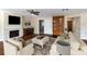 Inviting living room with a stone fireplace, built in shelving, and hardwood floors at 1228 Wagon Wheel Dr, Sarasota, FL 34240