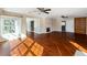 Spacious living room with hardwood floors, a stone fireplace, large windows, and plenty of natural light at 1228 Wagon Wheel Dr, Sarasota, FL 34240
