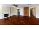 Open living room features hardwood floors, a stone fireplace, built-in bookshelves, and neutral walls at 1228 Wagon Wheel Dr, Sarasota, FL 34240