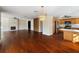 Open living space with hardwood floors, a stone fireplace, and a kitchen at 1228 Wagon Wheel Dr, Sarasota, FL 34240