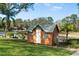 Exterior view of the charming playhouse with great lawn space and landscaping at 1228 Wagon Wheel Dr, Sarasota, FL 34240