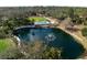 A large pond with fountain and swimming pool provide a beautiful backyard area at 1228 Wagon Wheel Dr, Sarasota, FL 34240