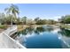 Community pond with fountain, dock, and lush surroundings for peaceful enjoyment at 1228 Wagon Wheel Dr, Sarasota, FL 34240
