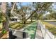 Community shuffleboard court with lush landscaping and benches for relaxing at 1228 Wagon Wheel Dr, Sarasota, FL 34240
