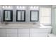 Bright bathroom featuring dual sinks, granite counters and stylish vanity lighting at 13227 Prestwick Creek Dr, Riverview, FL 33579