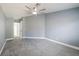 Bedroom featuring gray carpet, ceiling fan, and an en suite at 13227 Prestwick Creek Dr, Riverview, FL 33579