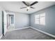 Neutral bedroom featuring plush carpeting, ceiling fan, and plenty of natural light at 13227 Prestwick Creek Dr, Riverview, FL 33579