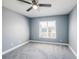 A spacious bedroom with gray walls and a ceiling fan at 13227 Prestwick Creek Dr, Riverview, FL 33579