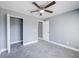 Bedroom featuring gray walls, ceiling fan, and closet with white door at 13227 Prestwick Creek Dr, Riverview, FL 33579