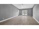Expansive bedroom features tile flooring, a ceiling fan, and double doors leading to the backyard at 13227 Prestwick Creek Dr, Riverview, FL 33579