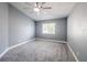 A gray bedroom has a ceiling fan, and carpeted floor at 13227 Prestwick Creek Dr, Riverview, FL 33579