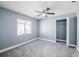 This bedroom features a ceiling fan, window, and a closet for ample storage at 13227 Prestwick Creek Dr, Riverview, FL 33579