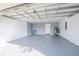 Spacious and clean garage interior with painted walls and floor, equipped with an electric water heater at 13227 Prestwick Creek Dr, Riverview, FL 33579