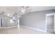 Expansive living room with vaulted ceilings, fan, tile floors, and view into kitchen at 13227 Prestwick Creek Dr, Riverview, FL 33579