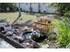 Landscaped backyard featuring a charming water feature, lush greenery, and peaceful surroundings at 13575 Martha Ave, Port Charlotte, FL 33981