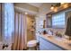 Bathroom with tiled shower, modern vanity, and decorative mirror offers a clean, updated space at 13575 Martha Ave, Port Charlotte, FL 33981