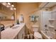 Bright bathroom featuring a marble countertop vanity, decorative mirror, and a shower-tub combo with a white shower curtain at 13575 Martha Ave, Port Charlotte, FL 33981