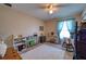 Versatile bedroom with bright window, wood-look tile, and ample space for flexible use at 13575 Martha Ave, Port Charlotte, FL 33981