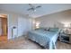 Cozy bedroom with wood-look tile, a ceiling fan, and a spacious closet at 13575 Martha Ave, Port Charlotte, FL 33981