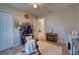 Charming bedroom featuring warm beige walls, decorative shelves, and cozy rocking chair with a fluffy white throw at 13575 Martha Ave, Port Charlotte, FL 33981
