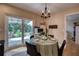 Dining area with outdoor access and kitchen pass-through provides a light filled space for entertaining at 13575 Martha Ave, Port Charlotte, FL 33981