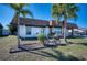 Inviting single-story home boasts a stone facade, tidy front yard, and an attached carport with driveway at 13575 Martha Ave, Port Charlotte, FL 33981
