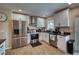 Modern kitchen featuring white cabinets, stainless steel appliances, granite countertops, and stylish fixtures at 13575 Martha Ave, Port Charlotte, FL 33981