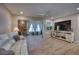 Open concept living room featuring a stone accent wall, neutral tones, recessed lights and tile floors at 13575 Martha Ave, Port Charlotte, FL 33981