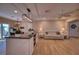 Open concept living room with wood-look tile flooring connects the kitchen to the Gathering area at 13575 Martha Ave, Port Charlotte, FL 33981