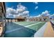 Outdoor shuffleboard courts under a clear blue sky, surrounded by community buildings at 13575 Martha Ave, Port Charlotte, FL 33981