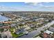 Aerial view of house on canal with water access surrounded by neighborhood at 23 Ocean Dr, Punta Gorda, FL 33950