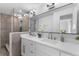 Stylish bathroom with double vanity, quartz countertops, and modern lighting at 23 Ocean Dr, Punta Gorda, FL 33950